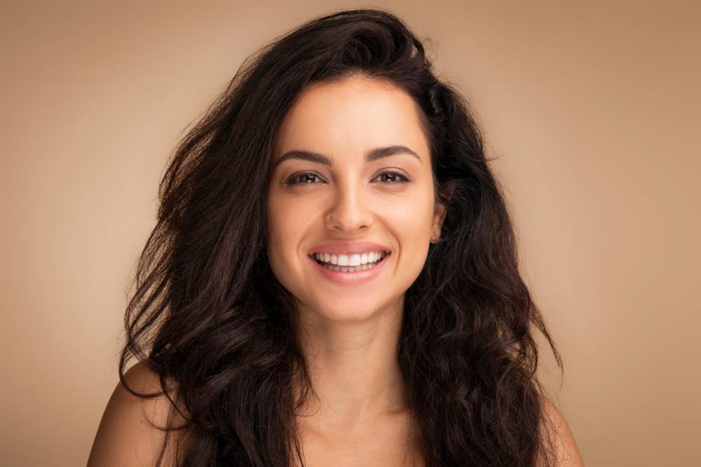 Woman with beautiful face shows off her rejuvenated look following PDO threads.