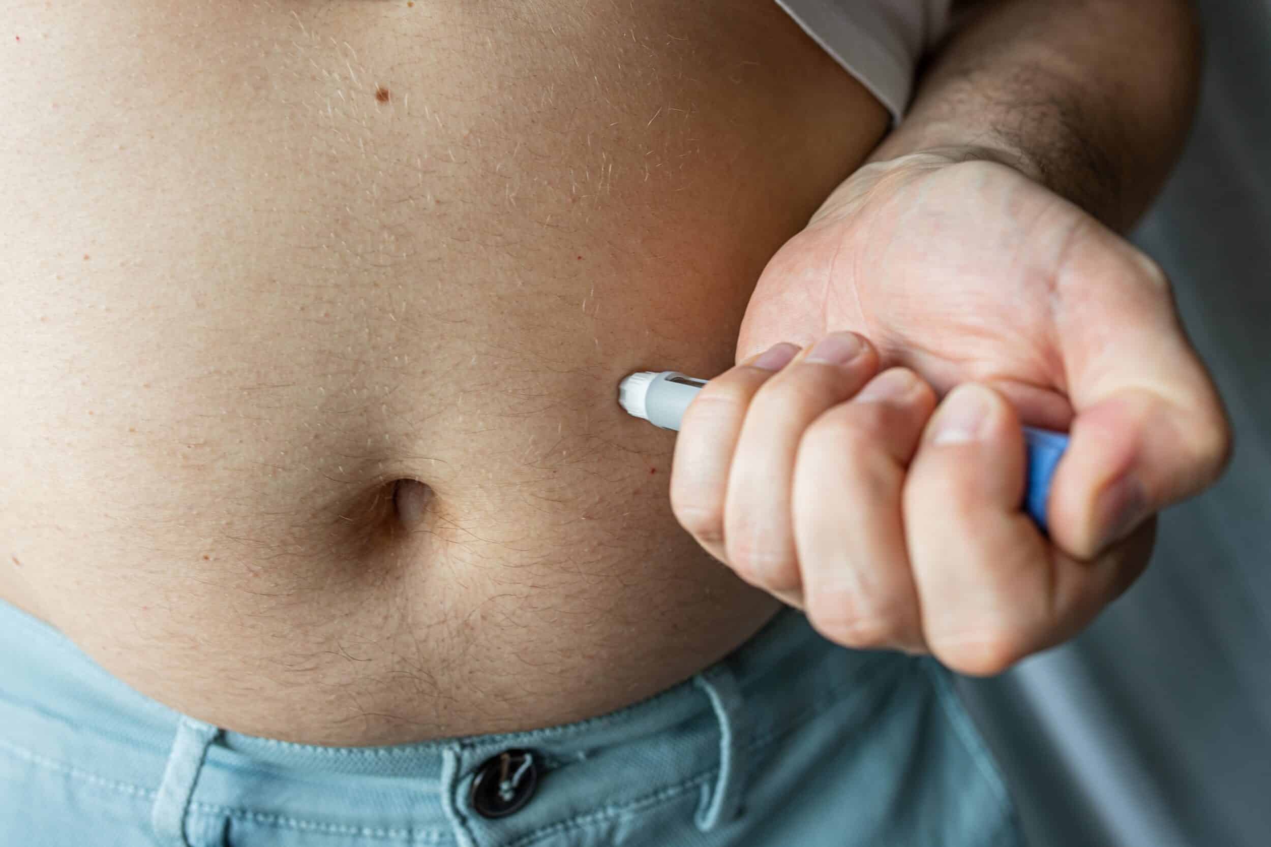Patient injects a GLP-1 medication in their abdomen for weight loss.