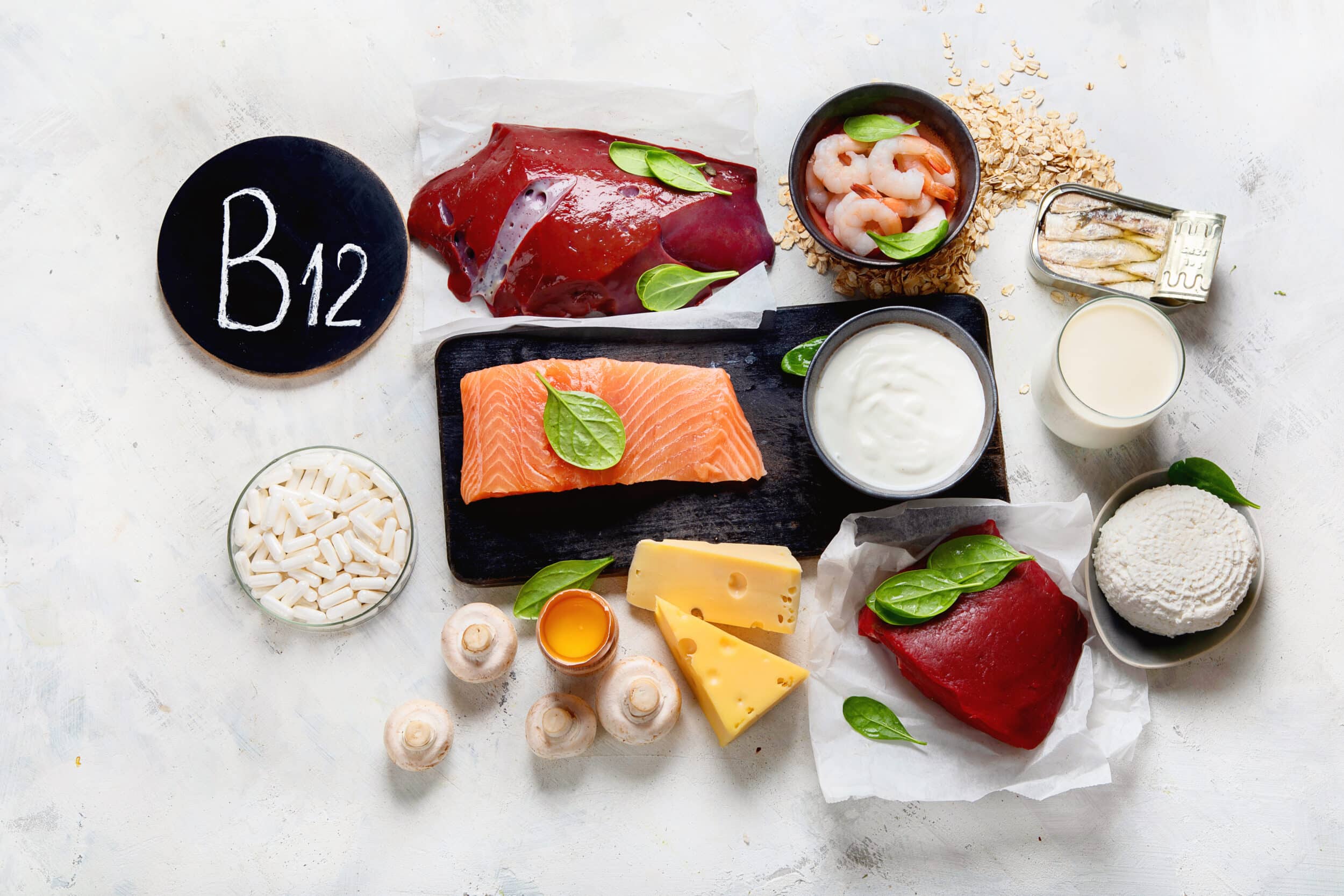 Image of foods such as salmon, cheese, and shrimp, with supplements in a bowl next to them to represent vitamin B12